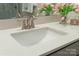 Close-up of a bathroom sink with quartz countertop, brushed nickel faucet, and a vase of fresh tulips at 131 Berkeley Ave # D, Mooresville, NC 28117