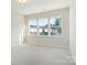 Sunlit bedroom with neutral carpet and large windows providing neighborhood views, bathed in soft natural light at 131 Berkeley Ave # D, Mooresville, NC 28117