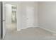 Bright, neutral bedroom featuring plush carpeting and an open doorway at 131 Berkeley Ave # D, Mooresville, NC 28117