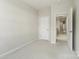 Neutral bedroom featuring an open doorway and a view to the hallway at 131 Berkeley Ave # D, Mooresville, NC 28117
