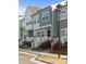 Attractive townhomes with manicured lawns and vibrant red roses lining walkway at 131 Berkeley Ave # D, Mooresville, NC 28117