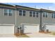 Exterior garages of new townhomes with gray siding; paved driveway at 131 Berkeley Ave # D, Mooresville, NC 28117