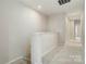Upstairs hallway with carpet and neutral colored walls leading to other rooms at 131 Berkeley Ave # D, Mooresville, NC 28117