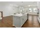 Island sink featuring modern faucet overlooking large open floor plan to living area at 131 Berkeley Ave # D, Mooresville, NC 28117