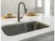 Close-up of kitchen sink on a white countertop, featuring a modern faucet and elegant floral accents at 131 Berkeley Ave # D, Mooresville, NC 28117