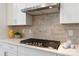 Gas stovetop and modern range hood over quartz counters in a well-appointed kitchen at 131 Berkeley Ave # D, Mooresville, NC 28117