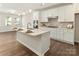 Open kitchen with stainless steel appliances and wooden floors at 131 Berkeley Ave # D, Mooresville, NC 28117