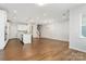 Open concept living room with kitchen and stairs at 131 Berkeley Ave # D, Mooresville, NC 28117