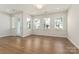 Bright living room featuring wood floors, modern windows and a glass door at 131 Berkeley Ave # D, Mooresville, NC 28117