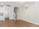 Open-concept living area with wood floors, stairway, and a stylish chandelier at 131 Berkeley Ave # D, Mooresville, NC 28117