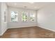 Sunlit living room with wood floors and large windows at 131 Berkeley Ave # D, Mooresville, NC 28117