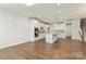 Bright living room with wooden floors and an open concept kitchen at 131 Berkeley Ave # D, Mooresville, NC 28117