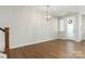 Bright living room with wood floors, modern lighting fixture, and a welcoming front door at 131 Berkeley Ave # D, Mooresville, NC 28117