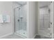 Modern tiled shower with glass door and chrome fixtures, adjacent to a walk-in closet for optimal convenience at 131 Berkeley Ave # D, Mooresville, NC 28117