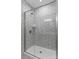 Close-up of a contemporary shower with glass door, featuring sleek chrome fixtures and geometric tile design at 131 Berkeley Ave # D, Mooresville, NC 28117