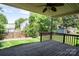 Wooden deck overlooking a lush backyard with a fence, shed and mature trees at 134 Walmsley Pl, Mooresville, NC 28117