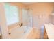 Bright bathroom showcasing a soaking tub with shower and large window at 134 Walmsley Pl, Mooresville, NC 28117