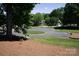 Beautiful view of community green space with bench seating and well-maintained landscaping at 134 Walmsley Pl, Mooresville, NC 28117