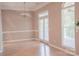 Elegant dining room featuring hardwood floors, chandelier, and bright french doors at 134 Walmsley Pl, Mooresville, NC 28117