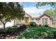 Charming home with a well-maintained lawn, beautiful landscaping, and a mix of brick and siding at 134 Walmsley Pl, Mooresville, NC 28117