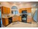 Well-lit kitchen featuring warm wood cabinetry, neutral countertops, and appliances at 134 Walmsley Pl, Mooresville, NC 28117
