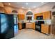 Bright kitchen with warm wood cabinets, neutral countertops, and black appliances at 134 Walmsley Pl, Mooresville, NC 28117