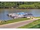 Picturesque lake view featuring boat docks, lush greenery, and serene waters at 134 Walmsley Pl, Mooresville, NC 28117