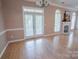 Bright living room with hardwood floors, a fireplace, and access to the patio through French doors at 134 Walmsley Pl, Mooresville, NC 28117