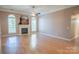 Spacious living room with wood floors, arched windows, and a cozy fireplace at 134 Walmsley Pl, Mooresville, NC 28117