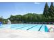 Relaxing community pool with lounge chairs and lifeguard stand, surrounded by lush greenery at 134 Walmsley Pl, Mooresville, NC 28117