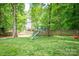 Lush backyard with a swing set, slide and seating area at 141 Culpeze Rd, Mooresville, NC 28117
