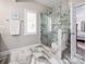 Bathroom featuring a frameless glass shower with marble tiling and a window with shutters at 141 Culpeze Rd, Mooresville, NC 28117