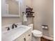 Cozy bathroom with modern vanity, decorative shelves, and hardwood floors at 141 Culpeze Rd, Mooresville, NC 28117