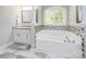 This bathroom features a soaking tub with decorative tile, granite countertop, and shutters on the window at 141 Culpeze Rd, Mooresville, NC 28117