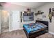 The bedroom features a black sports-themed decor, and a connecting door leading to the bathroom at 141 Culpeze Rd, Mooresville, NC 28117