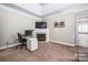 Bedroom with desk, fireplace, and view into attached bathroom at 141 Culpeze Rd, Mooresville, NC 28117