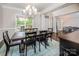 Elegant dining room with a large wood table, chandelier, and views to the outdoors at 141 Culpeze Rd, Mooresville, NC 28117