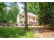 Rear exterior view of the home with a large backyard and rock drainage system at 141 Culpeze Rd, Mooresville, NC 28117
