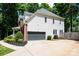 Exterior view of the home featuring a two-car garage, brick accents and manicured landscaping at 141 Culpeze Rd, Mooresville, NC 28117