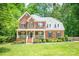 Charming two-story brick home with a welcoming front porch and beautifully landscaped front yard at 141 Culpeze Rd, Mooresville, NC 28117
