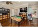 Hardwood floors can be found in this game room area with an open floor plan and entertainment features at 141 Culpeze Rd, Mooresville, NC 28117