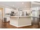 Bright kitchen features white cabinets, granite countertops, stainless steel appliances, and hardwood floors at 141 Culpeze Rd, Mooresville, NC 28117