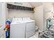 Bright laundry room featuring a washer and dryer, shelving for storage, and tile floors at 141 Culpeze Rd, Mooresville, NC 28117