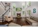 Cozy living room featuring a stone fireplace, large windows, and comfortable seating at 141 Culpeze Rd, Mooresville, NC 28117