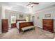 Main bedroom with tray ceiling, plush carpet, and traditional-style furniture at 141 Culpeze Rd, Mooresville, NC 28117