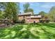 Large backyard with well-maintained lawn and mature trees at 14812 Stonegreen Ln, Huntersville, NC 28078