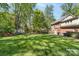 Expansive backyard with lush green grass and mature trees at 14812 Stonegreen Ln, Huntersville, NC 28078