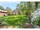 Expansive backyard featuring green grass, mature trees, and privacy fence at 14812 Stonegreen Ln, Huntersville, NC 28078