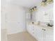 Bathroom featuring dual sinks with white cabinetry, tile flooring, and decorative lighting at 14812 Stonegreen Ln, Huntersville, NC 28078