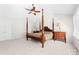 Spacious bedroom with a four-poster bed, ceiling fan, and neutral carpet flooring at 14812 Stonegreen Ln, Huntersville, NC 28078